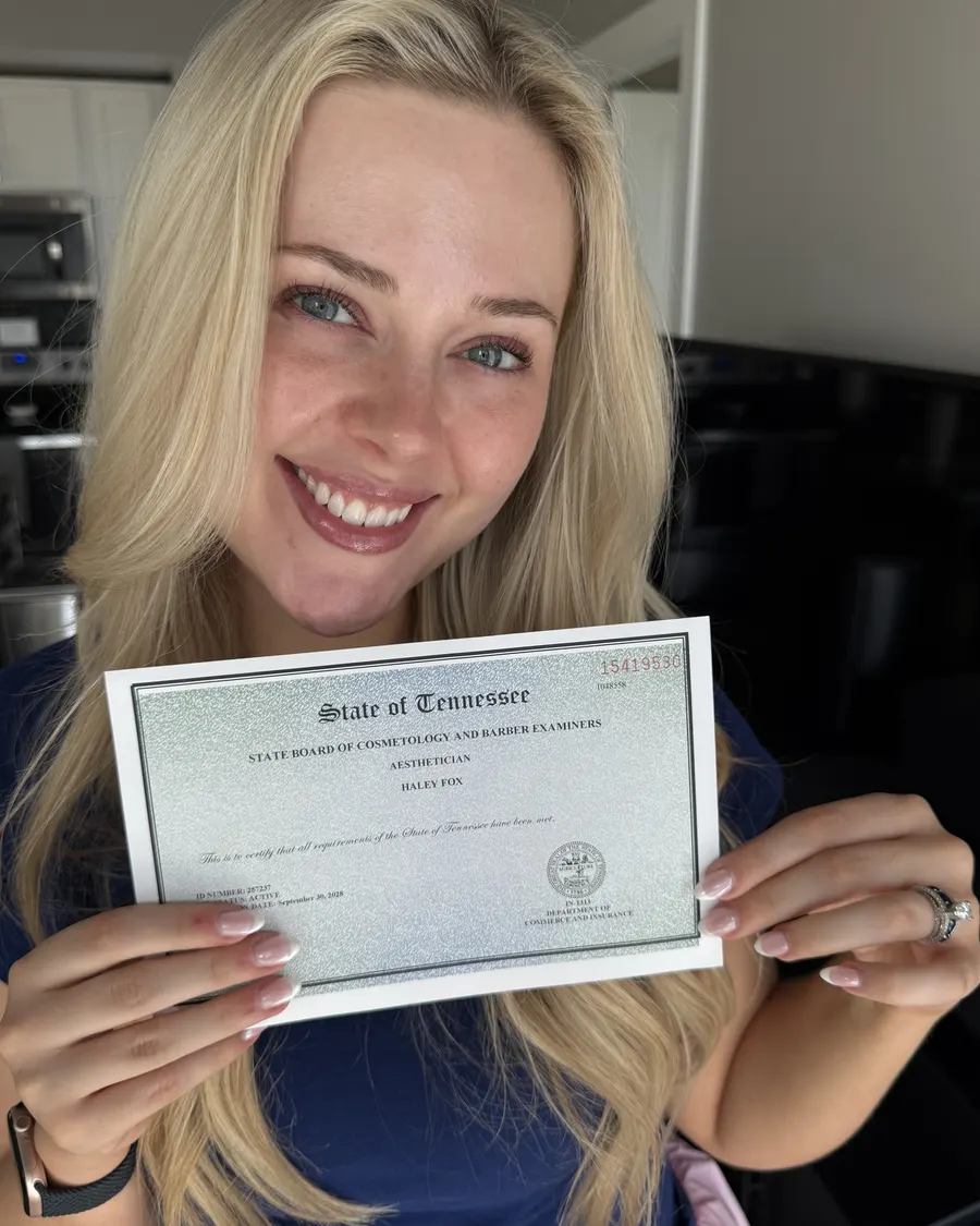 Haley holding her Tennessee aesthetician license certificate
