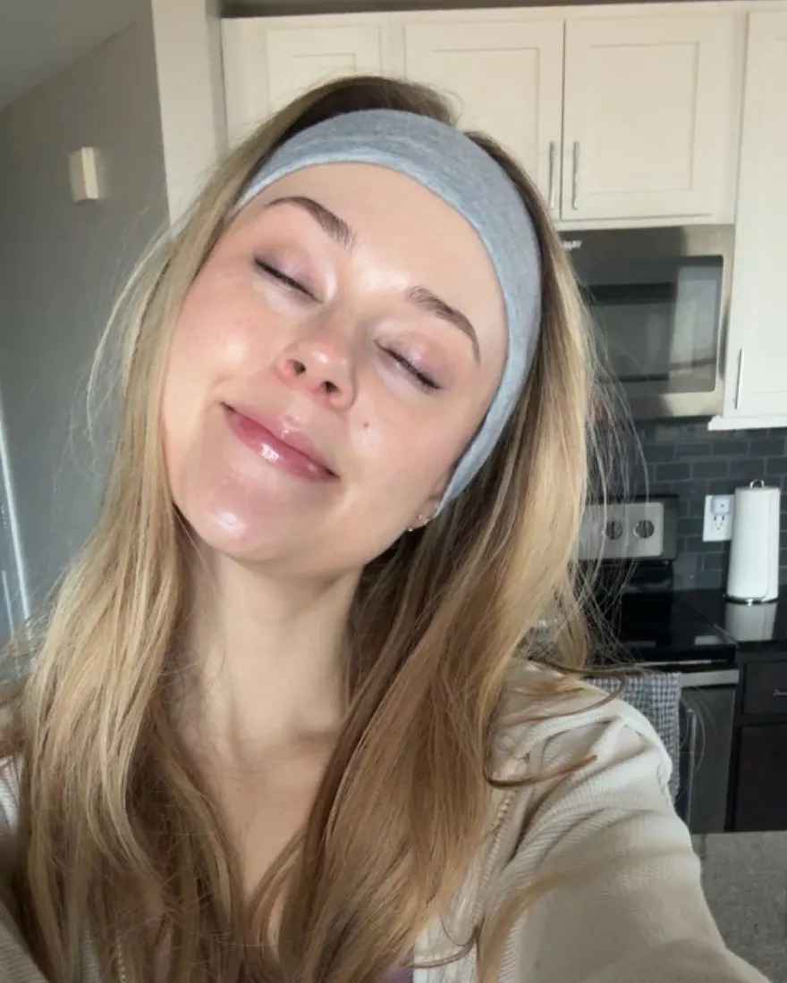 Haley in a headband, eyes closed, mid skincare routine